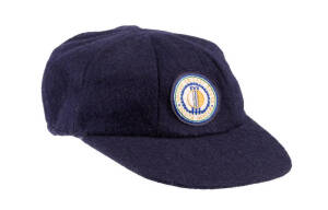 SOUTH AFRICA TEST CAP, navy blue wool, embroidered "United Cricket Board/South Africa" badge on front, player unknown. Used briefly when South Africa returned to Test cricket in 1990s, then replaced by a green cap in 1993. Given to the vendor by South Afr