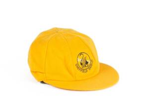 JUSTIN LANGER'S WESTERN AUSTRALIA CAP, yellow with embroidered "WACA/ Sheffield Shield" logo on front, signed inside by Justin Langer. G/VG condition. [Justin Langer played 105 Tests 1992-2007].