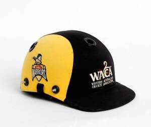 RYAN CAMPBELL'S WESTERN AUSTRALIA CRICKET HELMET, black & yellow, with embroidered "WACA/ Western Australia/ Cricket Association" logo on front, endorsed on side of helmet "OUCH!" and signed by Ryan Campbell & Brett Lee, no protective grill. Good match-us