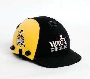 WESTERN AUSTRALIA CRICKET HELMET, black & yellow, with embroidered "WACA/ Western Australia/ Cricket Association" logo on front, player unknown, no protective grill. Good match-used condition.