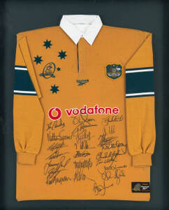 WALLABIES CENTENARY: Wallabies jersey with "Wallabies/100 Years/ 1899-1999" logo, with 23 signatures, window mounted, framed & glazed, overall 84x105cm.