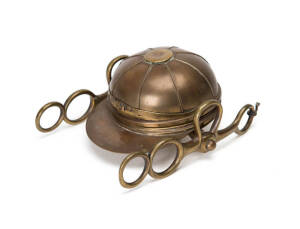 INKSTAND: An unusual brass inkstand in the form of a jockey's hat, French, 19th century, size 18x13cm.