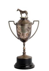 BALLARAT 1925 PRESIDENTS CUP: Trophy Cup, silver-plated, engraved "Ballarat & District Trotting Assn, Presidents Cup, 1925, Presented by C.H.Kennedy Esq, Won by Ragg Mauritius", lid with horse statuette finial, trophy on ebonised plinth, overall 42cm tall