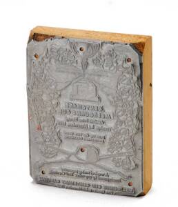 1960 MELBOURNE CUP: Printer's block with an advert for the Melbourne Cup Centenary Carnival, metal on timber base, size 8x10cm.