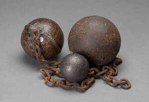 Two convict ball and chains and a lead&nbsp;cannon ball, the&nbsp;largest 13cm diameter