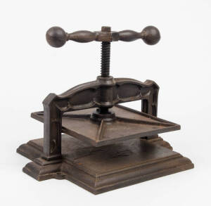 Cast iron book press of ornate form. Mid to late 19th Century, 38cm.