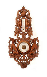 A good wall barometer and themometer, carved with hunting dogs and other animals, Swiss, 19th Century. 94cm long, 51cm wide.