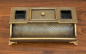 A brass inlaid ink stand, French circa 1830. 36cm wide, 7cm deep.