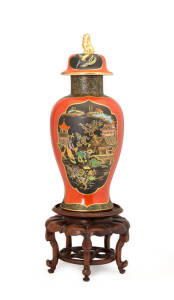 W & R Carlton ware lidded temple jar with unusual terracotta ground, circa 1925. Resting on carved Chinese timber stand. Vase 37cm.