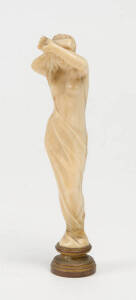 A finely carved ivory seal in the form of a naked maiden, French 19th Century 12cm high