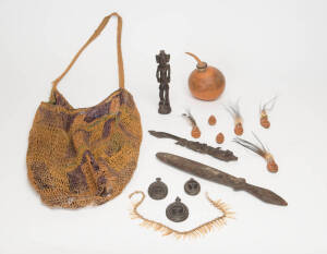 Papua New Guinea artifacts. Group collected in the mid 20th century: Billum bag, dog tooth necklace, carved gourd bottle, sword club, wood carvings (2), Huon Bay carved wooden charms (3), carved nuts with applied trade beads & feathers (6). (15 items)