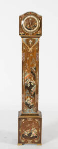 A small elaborately-embellished longcase clock