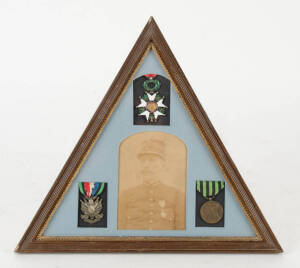 Franco-Prussian war veteran triangular framed display with portrait photograph & 3 medals; Legion of Honour, Veterans medal & service medal. 35cm