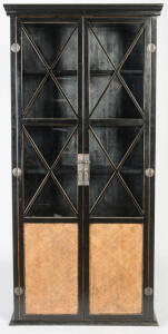 Chinese style ebonised two door free standing book case with rattan panels. 225cm high, 108cm width, 40cm depth.