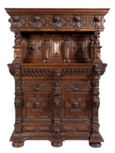 COURT CABINET: Ornately carved oak with lions masks and faces. Early 19th century. 220cm high, 157cm wide, 70cm deep.