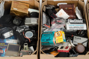 A large and varied group of photographic accessories. The group with six boxes containing camera bags, straps, lens front- and rear caps, body caps, metal film canisters, filters and numerous other photographic items. (6 boxes - several hundred items)