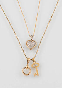 Three gold necklaces, including a diamond heart, 14k and 18k yellow gold.