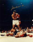 MUHAMMAD ALI, signed colour photograph of Ali standing over Sonny Liston, size 28x35cm.