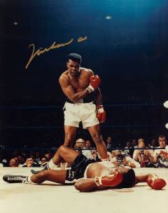 MUHAMMAD ALI, signed colour photograph of Ali standing over Sonny Liston, size 28x35cm. With CoA #0473.