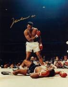 MUHAMMAD ALI, signed colour photograph of Ali standing over Sonny Liston, size 28x35cm. With CoA #0473.