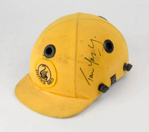 TOM MOODY'S WESTERN AUSTRALIA CRICKET HELMET, yellow, with "WACA/ SHEFFIELD SHIELD" badge on front, signed on side of helmet by Tom Moody, no protective grill. Fair/Good match-used condition. [Tom Moody played 8 Tests & 76 ODIs 1987-2000].