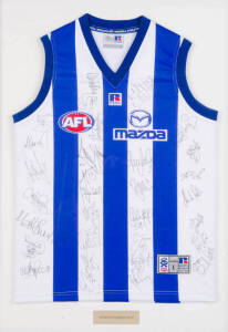 NORTH MELBOURNE: North Melbourne football jumper signed by 2003 team, with c30 signatures, window mounted, framed & glazed, overall 67x92cm.